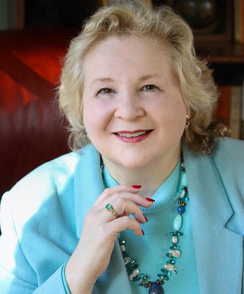 Debbie Ausburn wearing light blue coat headshot photo